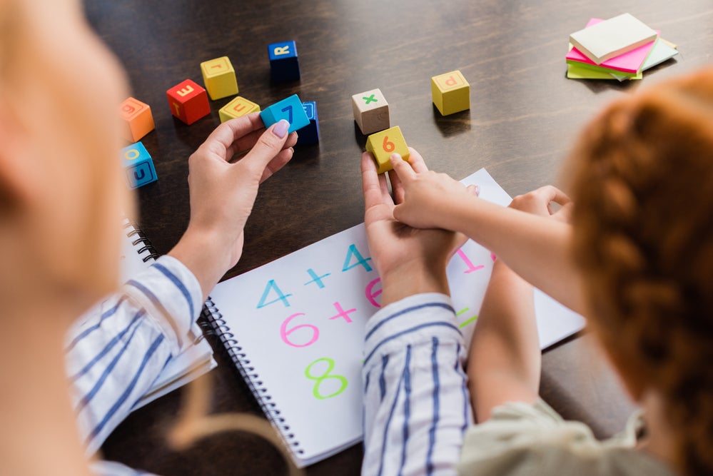 Parent helping child with number recognition