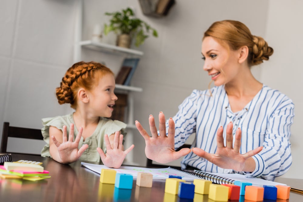 Parent and child playing a game to work on recognizing numbers