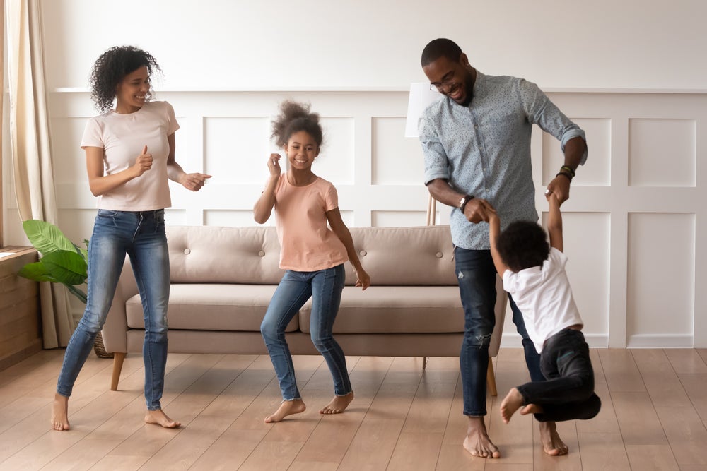 Family dancing in living room