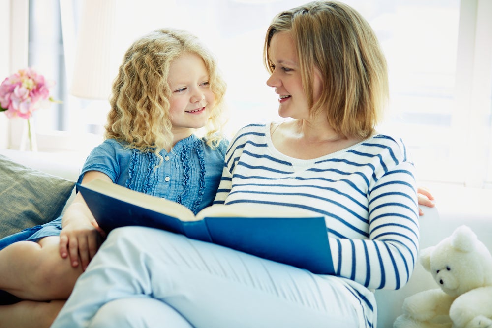 Mother reading to her child, pointing out adjectives