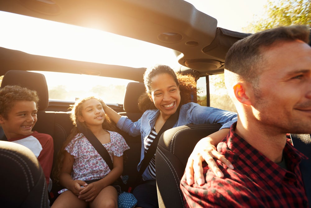 Happy family on a road trip in car