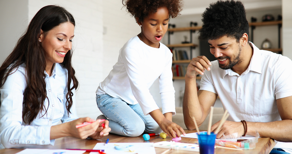 Mom and Dad join their daughter in playing educational sight word games at home