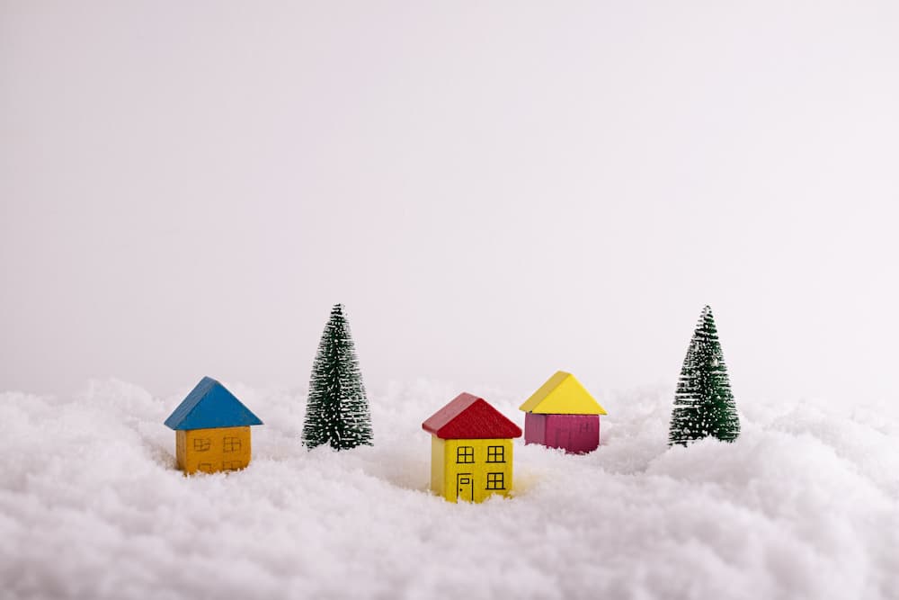 Block houses and fake trees in fake snow for a winter diorama