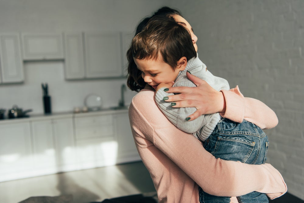 Mom giving child a hug