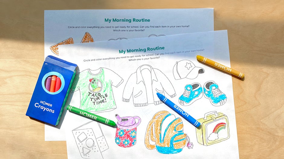 Completed morning routine printable with crayons on table