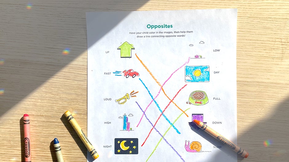 Completed Opposites printable on table with crayons