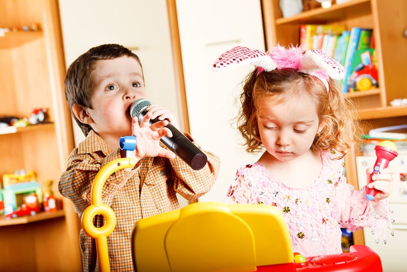 Kids singing and playing a toy piano