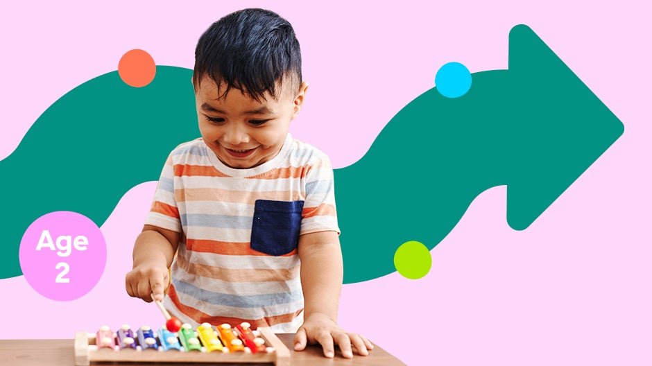 Stylized graphic: smiling 2-year-old playing xylophone with text Age 2 to his side and squiggly arrow behind him
