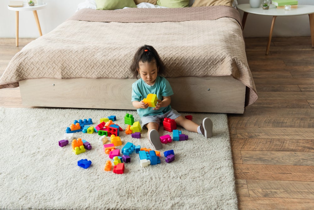 Girl playing with blocks on floor