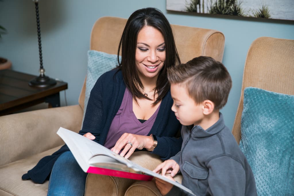 Adult reading child book about friendship