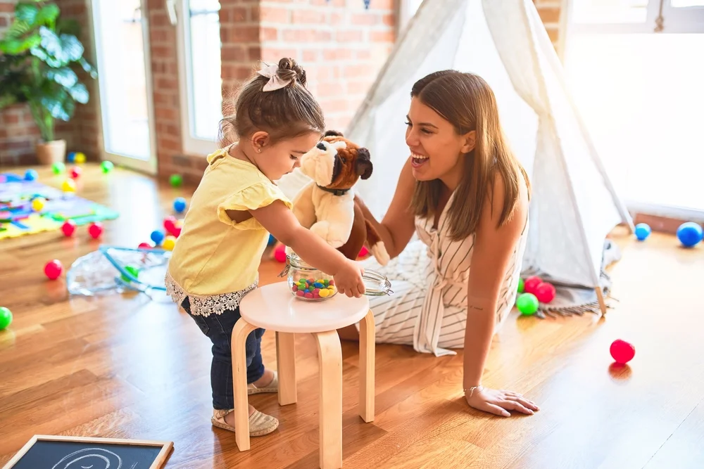 Mom playing with child with friendly stuffed dog