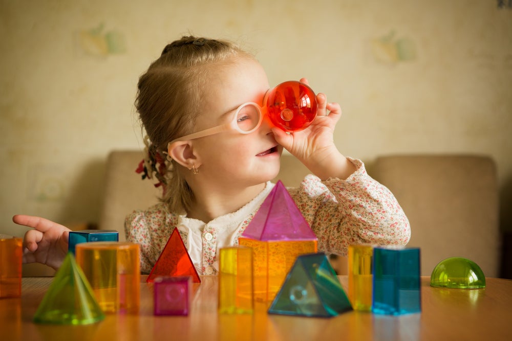 Preschooler playing with magnetic tile shapes