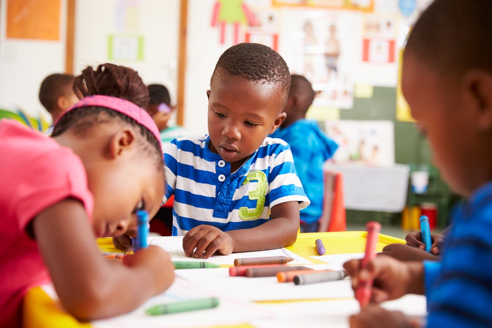 Preschoolers drawing with crayons