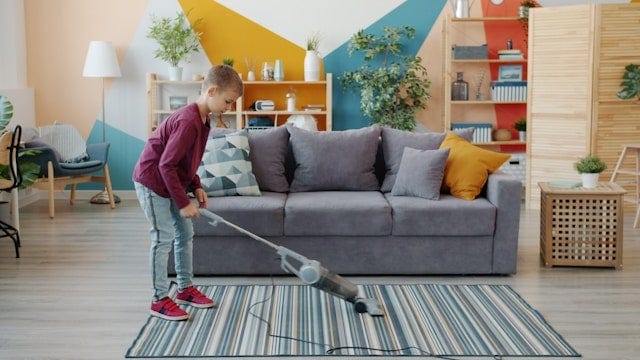 Child vacuuming carpet