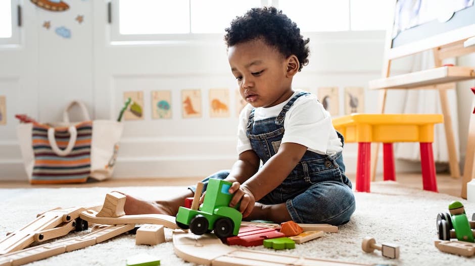 Boy playing with a toy train set