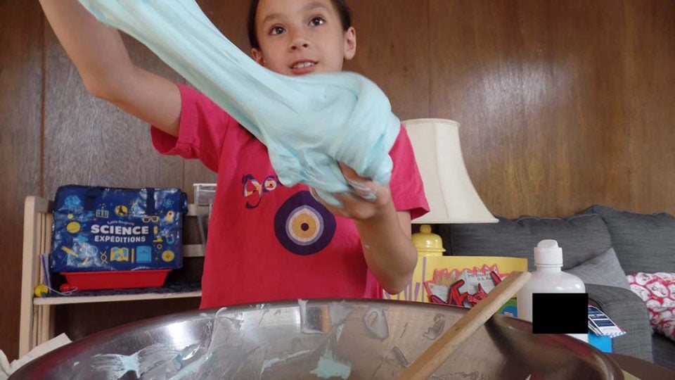 Kid playing with fluffy slime