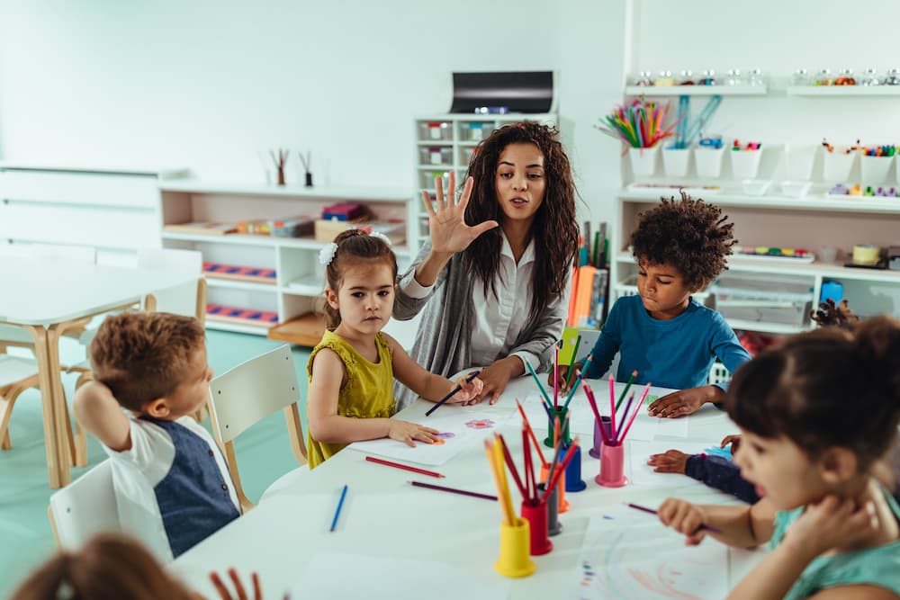 Teacher and kids playing Simon Says art game in classroom