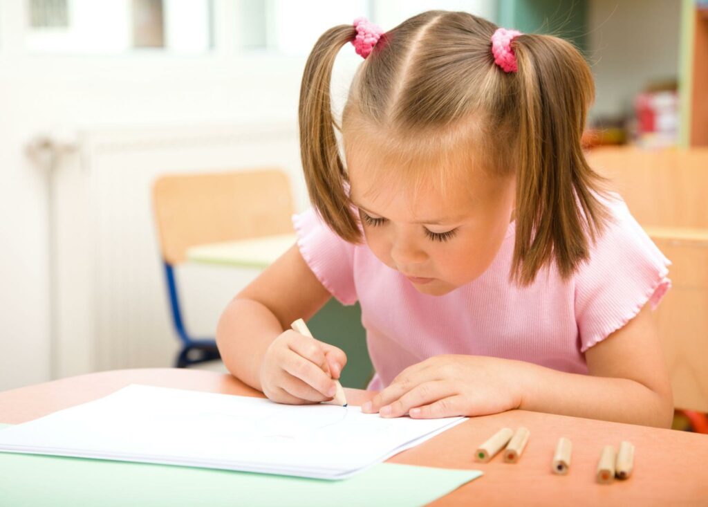 Girl doing SEL activity with pencil and paper