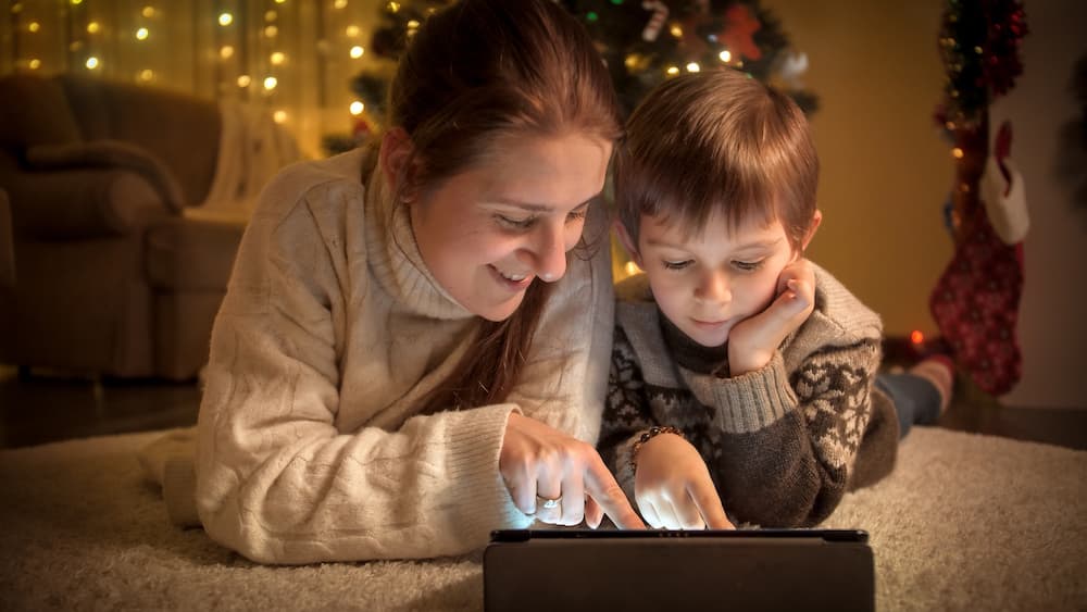 Mother and son enjoying screen time together during the holidays