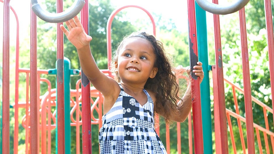 A young girl confidently performing an activity, representing the importance of confidence in children's development.