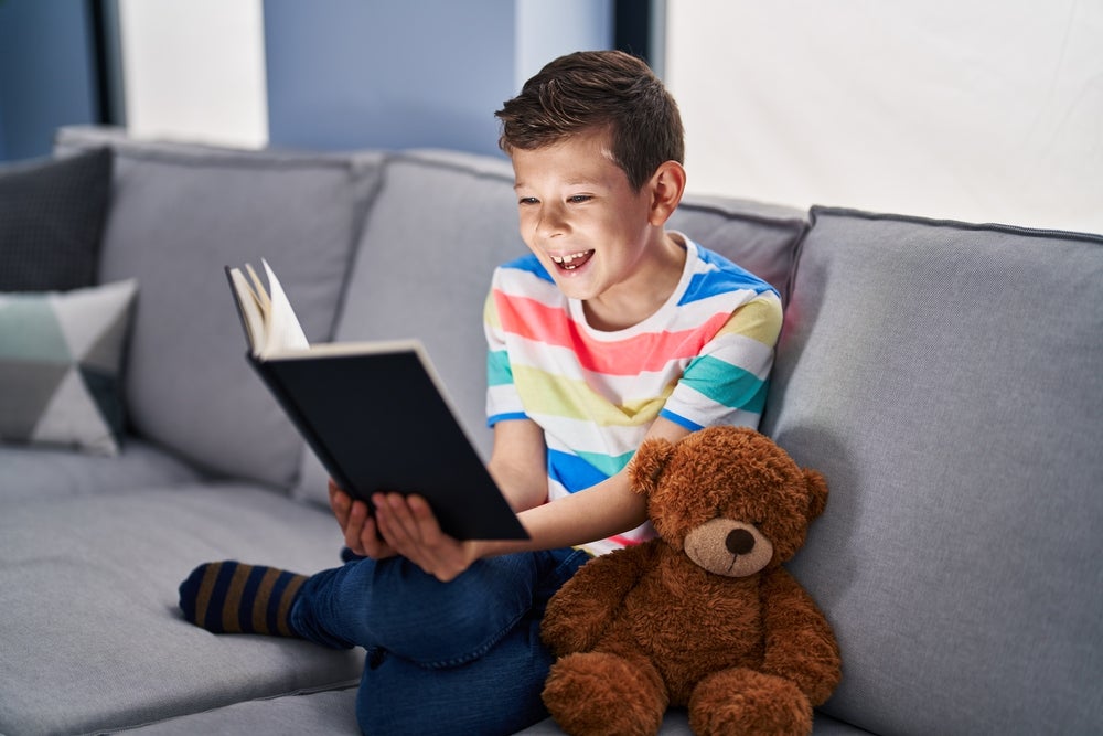 young kid reading decodable books