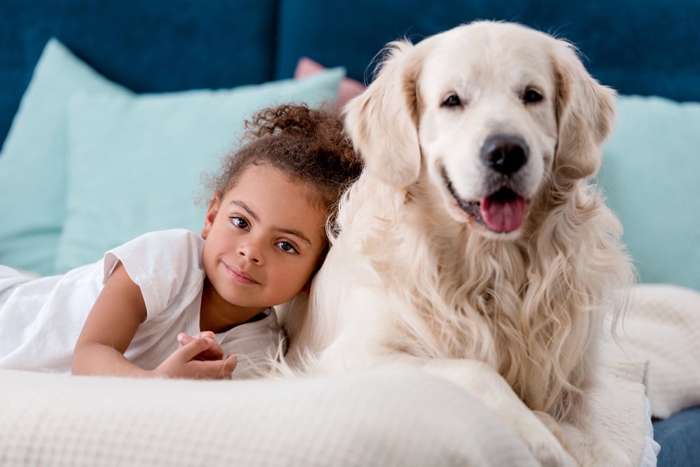 Animal Facts for Kids - young girl laying next to her dog