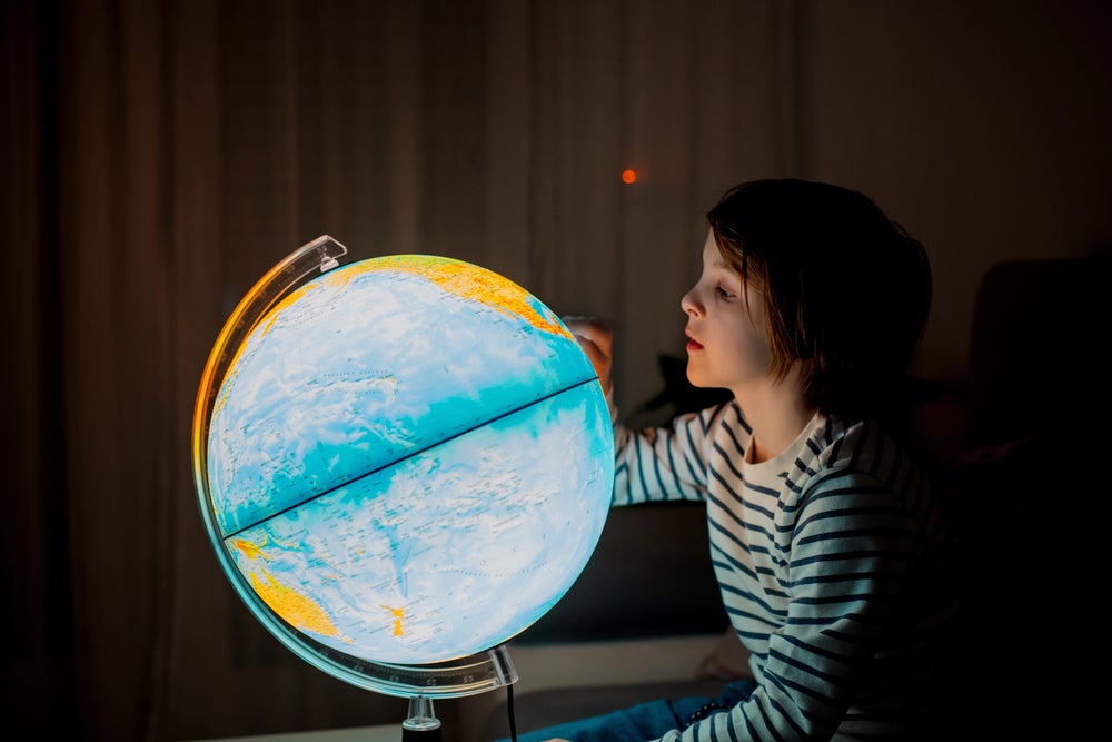 Place Facts for Kids - Kid looking at a globe