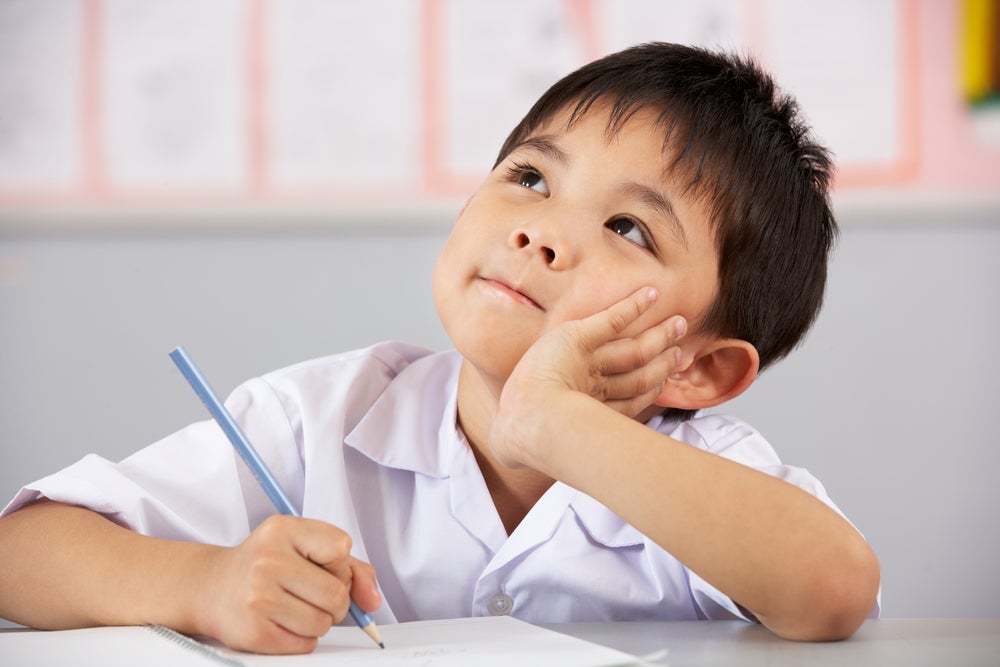 Kid thinking about his 1st grade writing prompts
