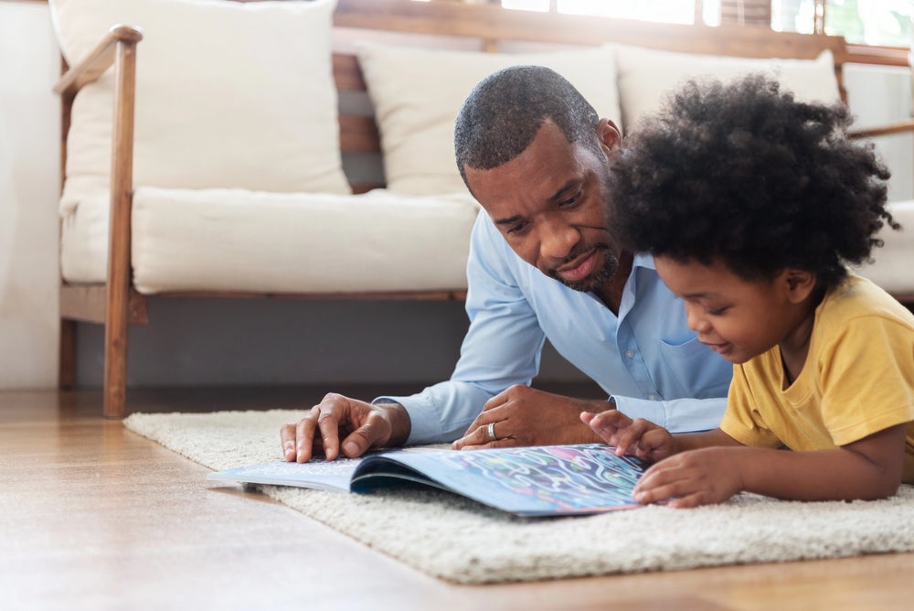 father and child reading together