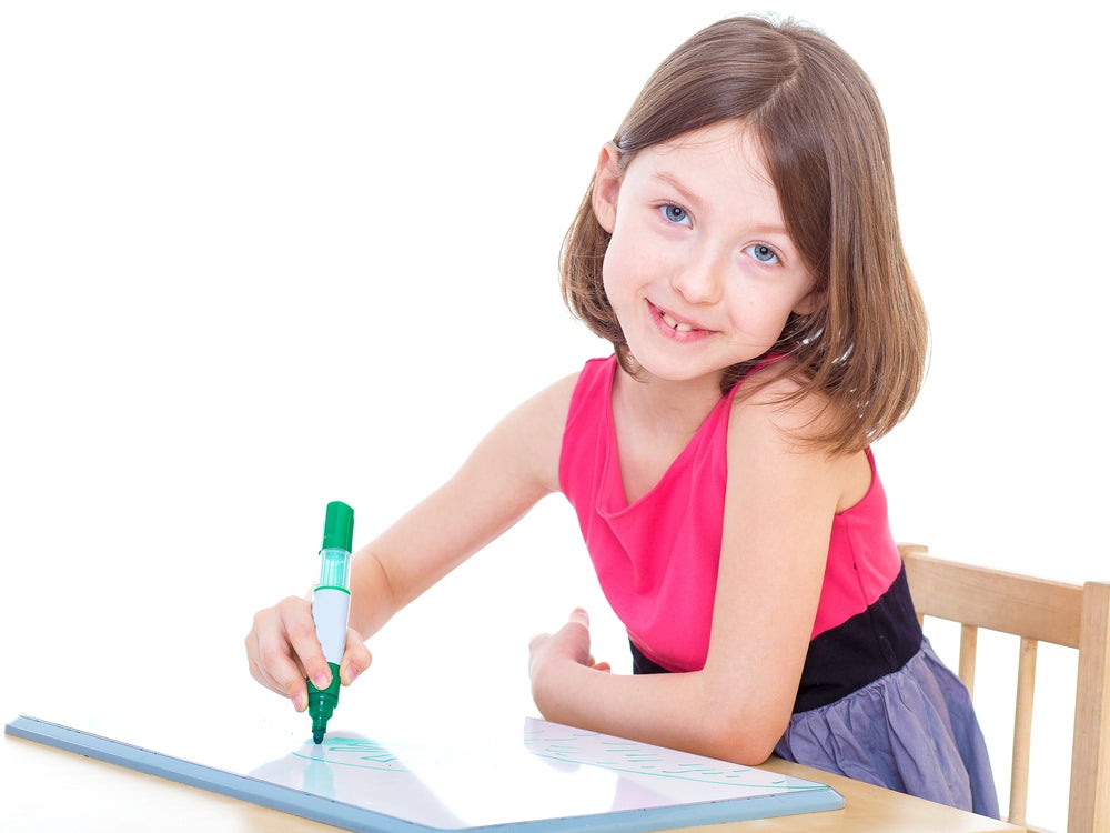 young girl writing words that start with the letter C