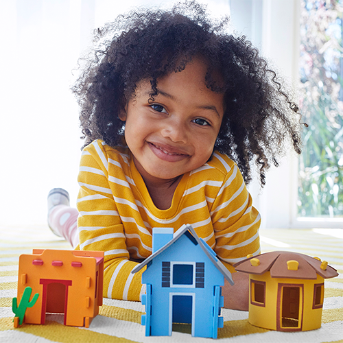 child sitting in front of educational toys