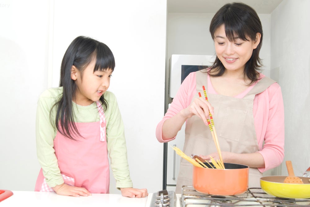 mother and daughter cooking together