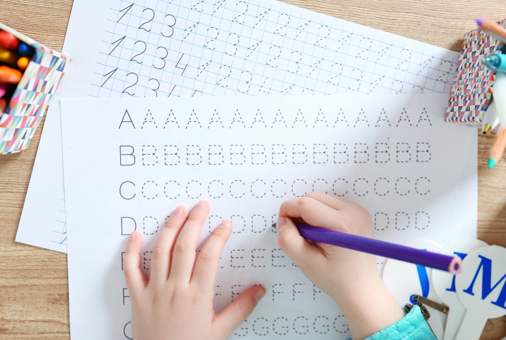 5 year old practicing letter tracing worksheets