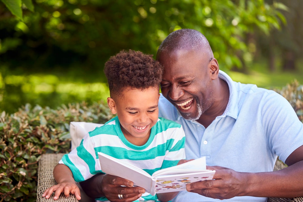 father helping his son learn to read