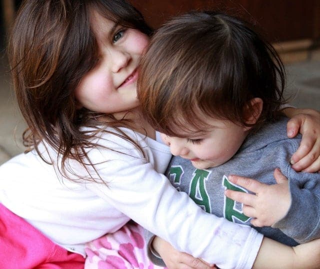 two kids hugging