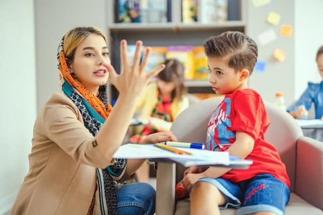 teacher helping kid with math