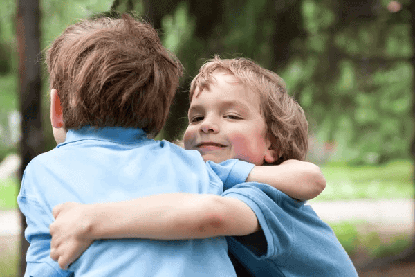 two kids hugging and showing respect