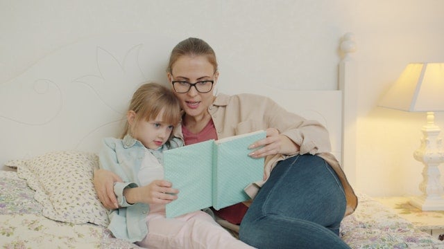 Mom reading books as a bedtime routine for kids