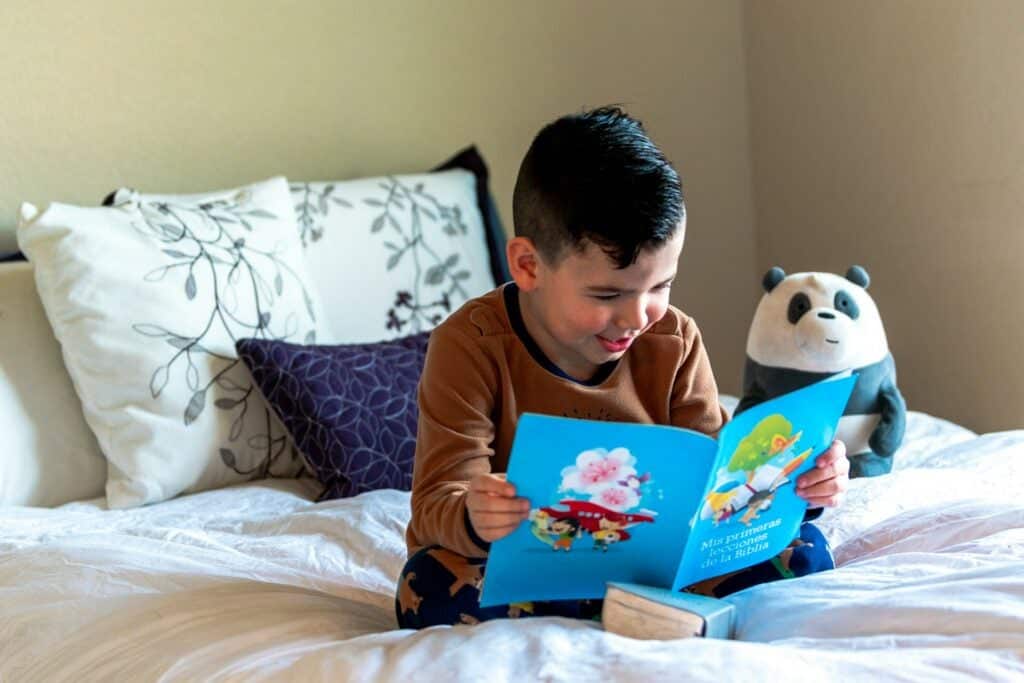 young kid reading as his bedtime routine for kids