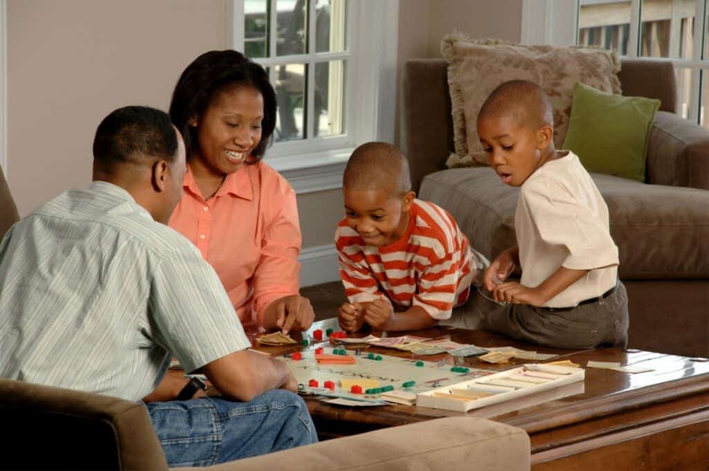 Parents playing monopoly with kids